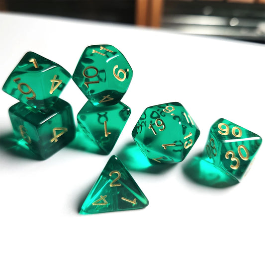 Set of translucent green polyhedral dice with gold numbers on a white surface