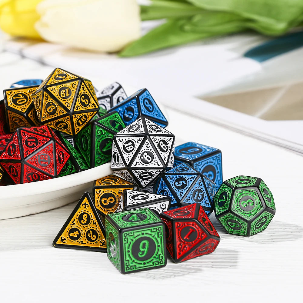 Set of colorful polyhedral dice on a white surface with flowers in the background