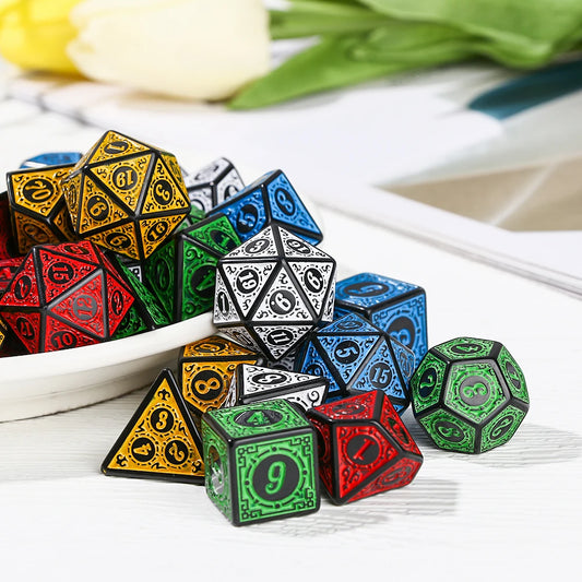 Set of colorful polyhedral dice on a white surface with flowers in the background